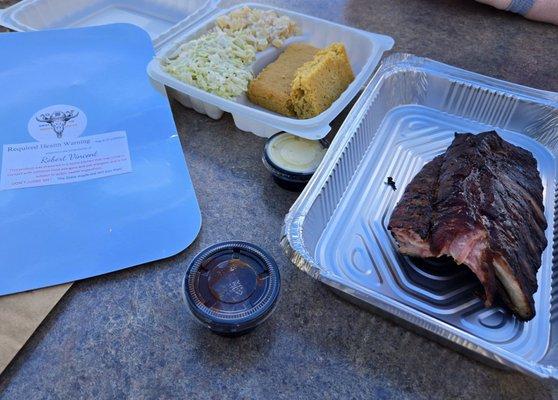 Half rack of ribs, cornbread, potato salad, and coleslaw. They also make the honey butter, and that is jalapeño sauce.