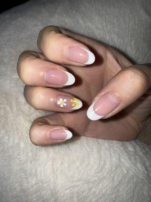 Almond shape, french tip manicure with flower design on the accent nail!