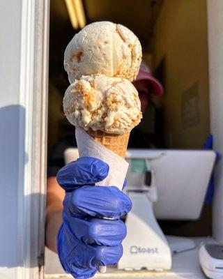 Banana pudding ice cream on a sugar cone.