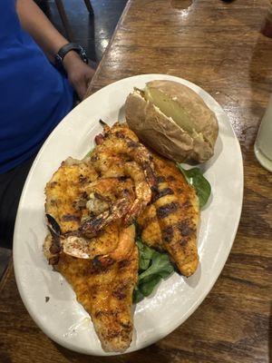 Grill, fish, and shrimp combination with baked potato