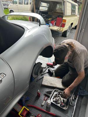 Ron Erwin of Erwin's Mobile Mechanics at work on the rear brakes of my 2000 BMW Z3.2.3