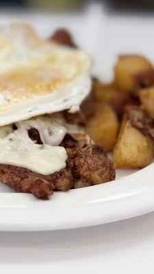 Eggs over medium with cheese melted on top of fresh hash and a side of home fries!!!