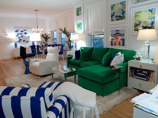A emerald green velvet sofa
Brings the outside inside this navy and white nautical penthouse