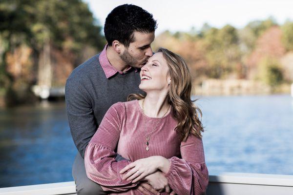 engage couple at the lake kissing