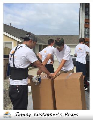 Making sure boxes are properly taped before placing them into the truck.