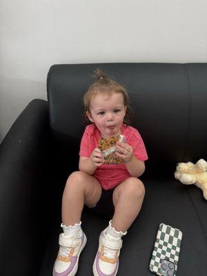 Quinn enjoying a cookie from neighboring store, Thunder Mug and Breadcrumbs