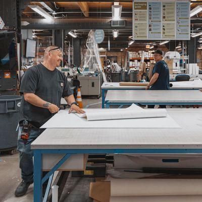 Cushing's production team working and smiling in the print shop.