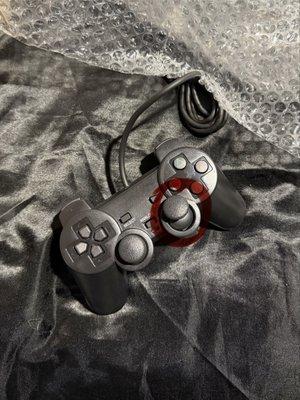 Not a Sony Dual Shock controller. Right thumb stick is visibly broken.