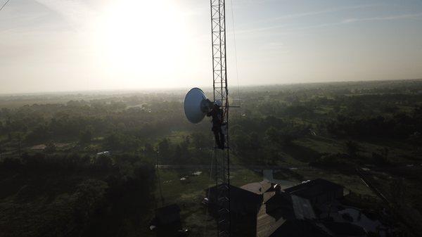 Technician ligning a new radio on one of our towers.
