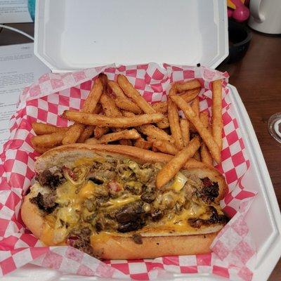 Beef philly cheesesteak with fries.