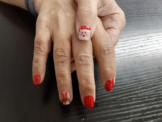 Santa and reindeer gel manicure. Artwork is done by hand.