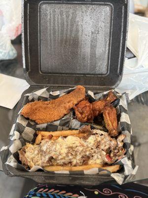 Philly cheesesteak fries, chicken wings, and fried fish.