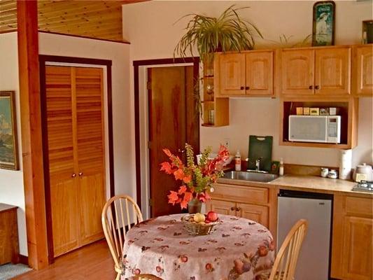 kitchen table, sink, fridge, closet & bathroom door