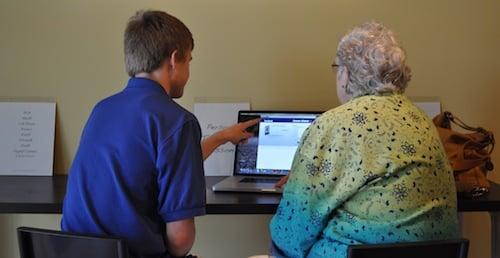 Everett Wickham giving a computer lesson.