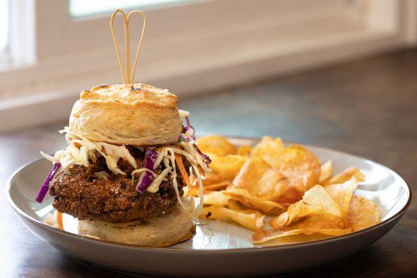 Corn Meal Battered Fried Chicken on our House Made Biscuit, topped with Jalapeno Slaw and Rosemary Hot Honey.