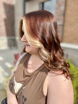 This is a money piece with red hair