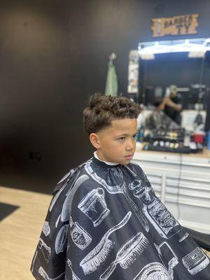 Barber Ty gave this kid a nice and clean taper with lineup.