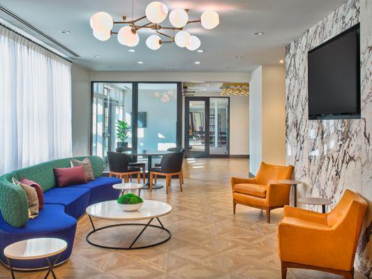 Plush seating in lounge area amenity space.