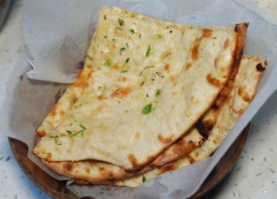 The GARLIC NAAN is soft and fluffy and served hot off the TANDOOR!
