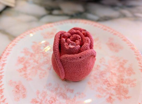 Mini Rose (chocolate sponge cake, pistacchio crumbs, rhum mousse, raspberry gelee, passion fruit, mango mousse). $12