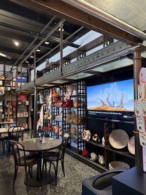 Tables set up inside the gift shop to enjoy the coffee and light bites.