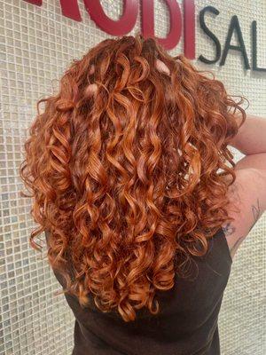Red curls cut and styled with the signature Ouidad haircut