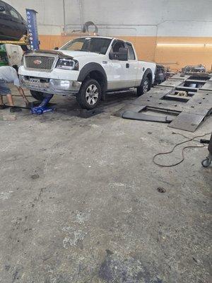 My truck being serviced and diagnosed for front clunking sounds.