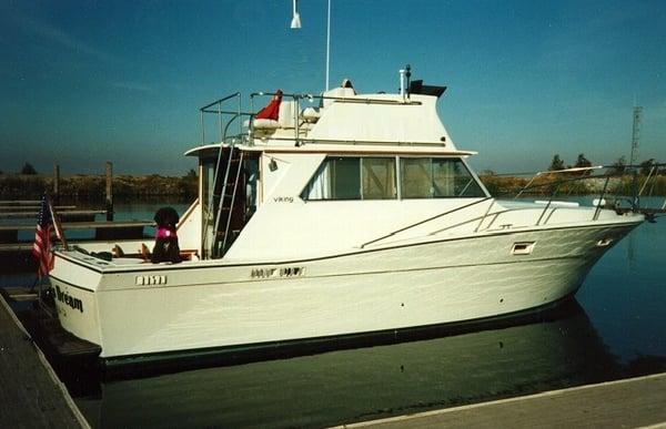 Skipper's Dream while moored at Westgate Landing, showing Skipper, the yacht's namesake Portuguese Water Dog.