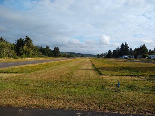 Grass strip parallel to the main strip, short at around 1300' but a nice alternative for those so inclined.