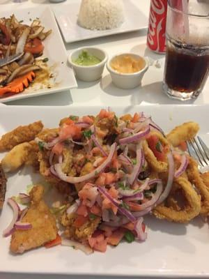 Fried fish with seafood and a delicious salad on top.