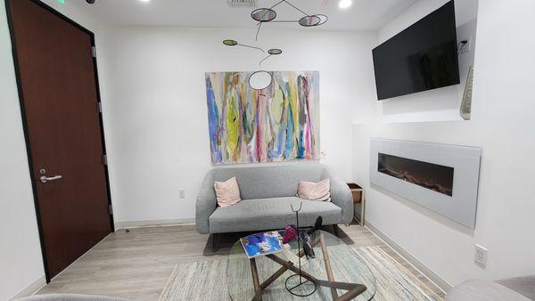 Waiting room with artwork by Dr Perea's wife