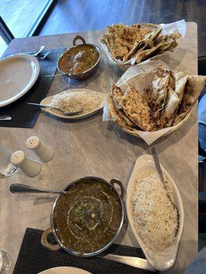 Chicken xacuti, chicken saag, fragrant rice and an assorted naan basket.
