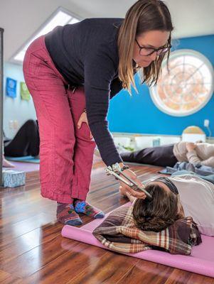 Using a weighted tuning fork on the head for a calming and grounding