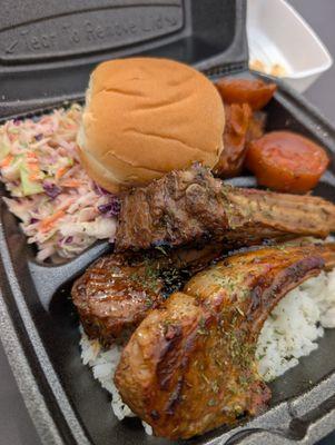 Lamb Chops on a bed of rice with sides of Candied Yams, and coleslaw. Served with a Bun.