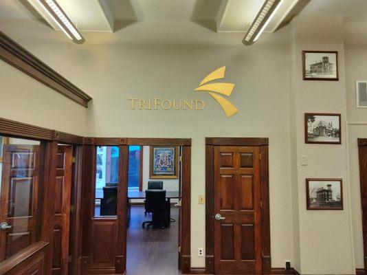 Our brass sign above the conference room entrance