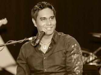 Pastor Navin leading the congregation in song and worship.