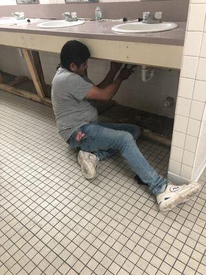 Plumber doing plumbing.
