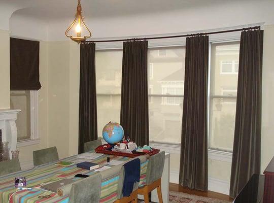 custom curved rod with 4 panels of curtains and a matching roman shade