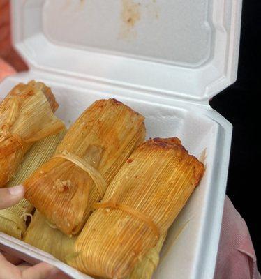 Red sauce pork tamales on top and green sauce pork tamales on the bottom