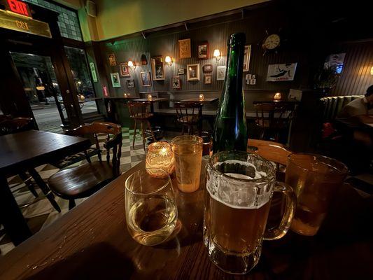 Inside. Having a glass of wine and beer. Water brought upon seating