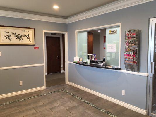 Behind the sliding frosted glass doors is the receptionist area.