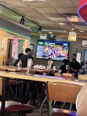 Group of staff taking up tables in the bar.
