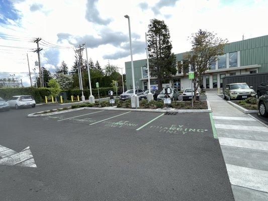 Crowded parking lot with abundance of unused charging spaces.