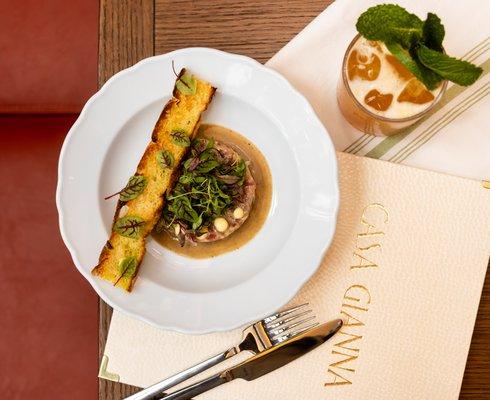 "Tuna Tartare with chives, shallots, capers, meyer lemon aioli, truffle vinaigrette