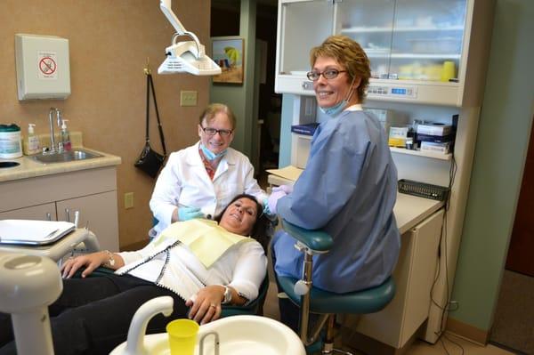 Dr. Ricotta, Liz (Dr. Ricotta's assistant) and our happy patient getting her new porcelain crown cemented.