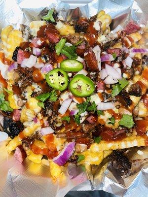 BBQ Loaded fries! Fries loaded with beans, queso, brisket and topped with diced onions, cilantro and bbq sauce!