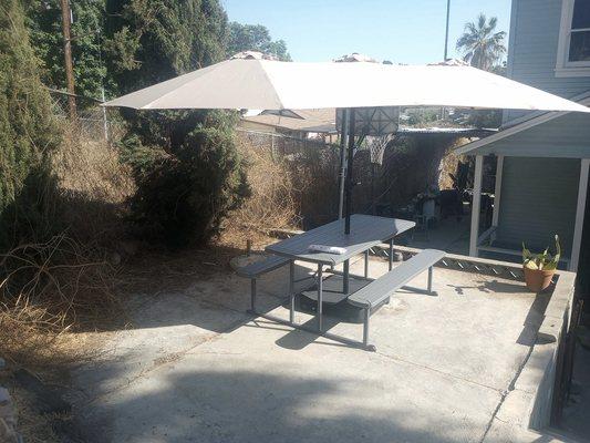 Assembled a patio table with attached benches and a practical triple-canopy umbrella.