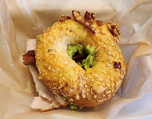 Turkey, bacon, avocado sandwich on a bacon Asiago bagel