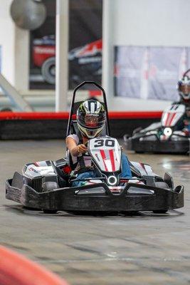 A teenager races in a go-kart at K1 Speed Harrisburg during a teen birthday party.