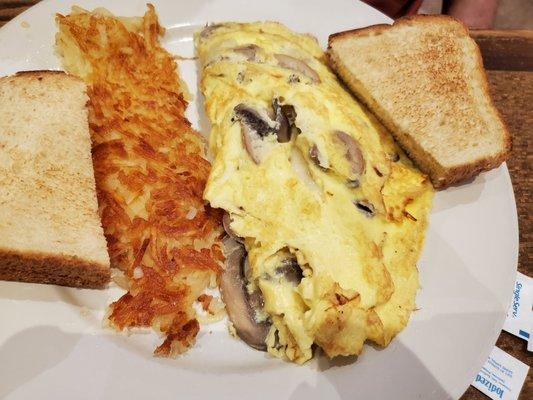 Mushroom and cheese omelet with hash browns and toast